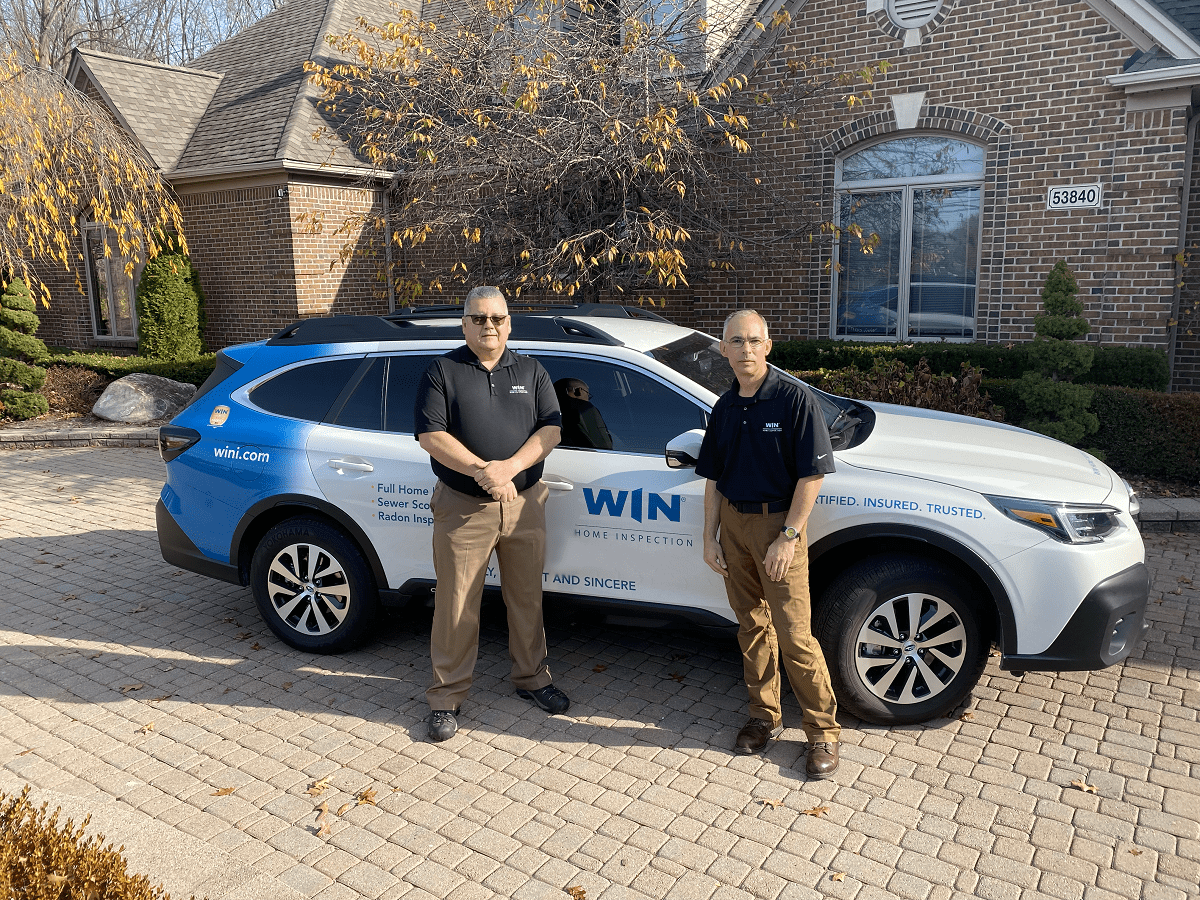 WIN Home Inspection Business Owners with their WIN Branded Vehicle