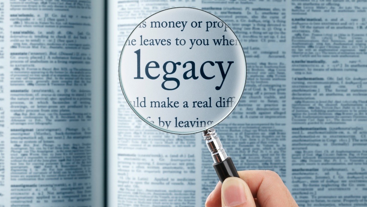 Magnifying glass on the "Legacy" in dictionary