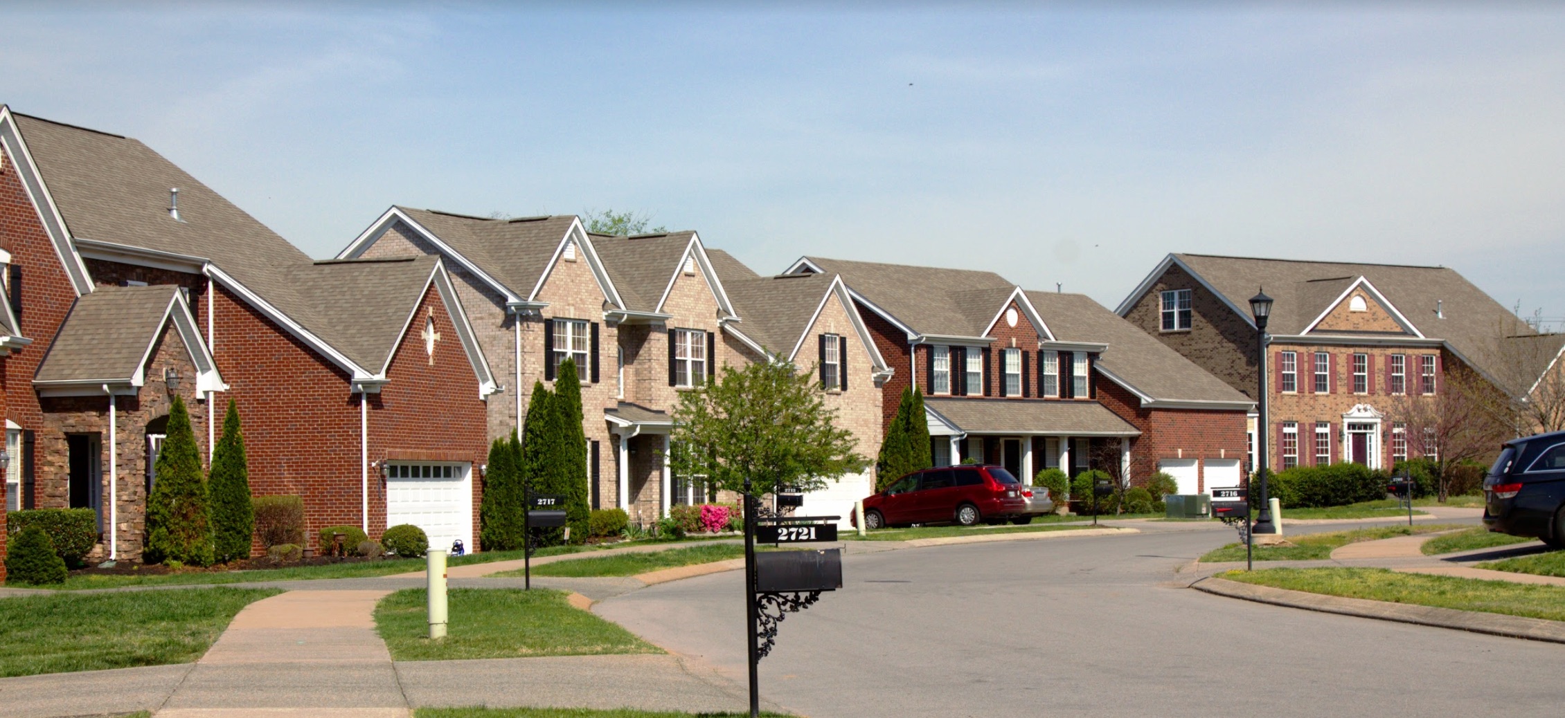 A row of two-story houses on a suburban street.