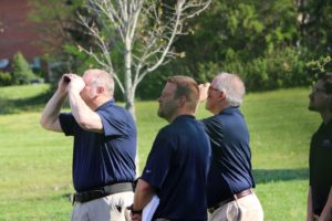 A trainer and three trainees peer through binoculars during the training that’s part of starting a home inspection business with WIN.