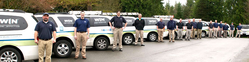 WIN home inspectors with vans in parking lot