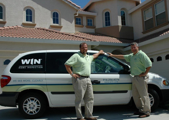 Two WIN home inspectors in front of WIN van