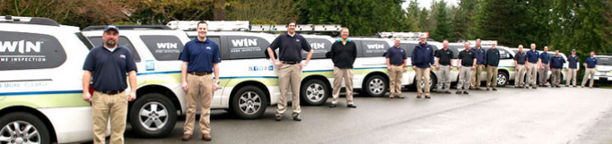 WIN Home Inspectors in front of WIN vans in parking lot