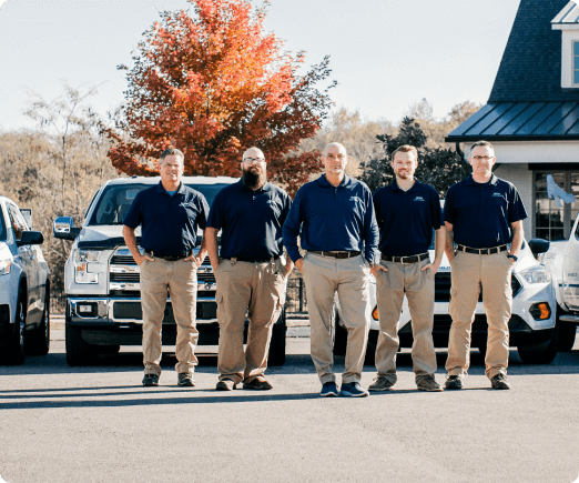 Group of home inspector posing in front of their vehicles