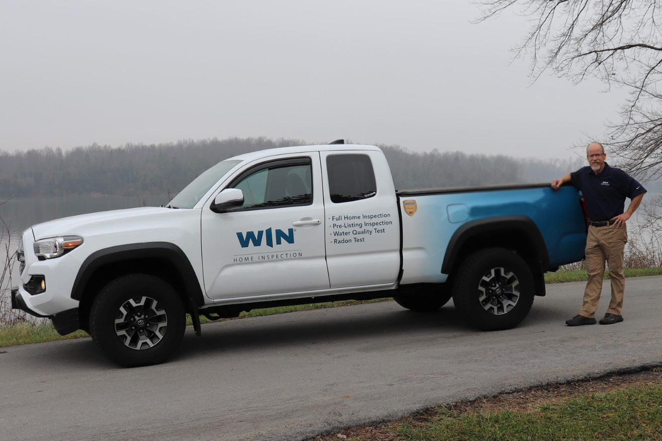 WIN Home Inspector with WIN branded vehicle