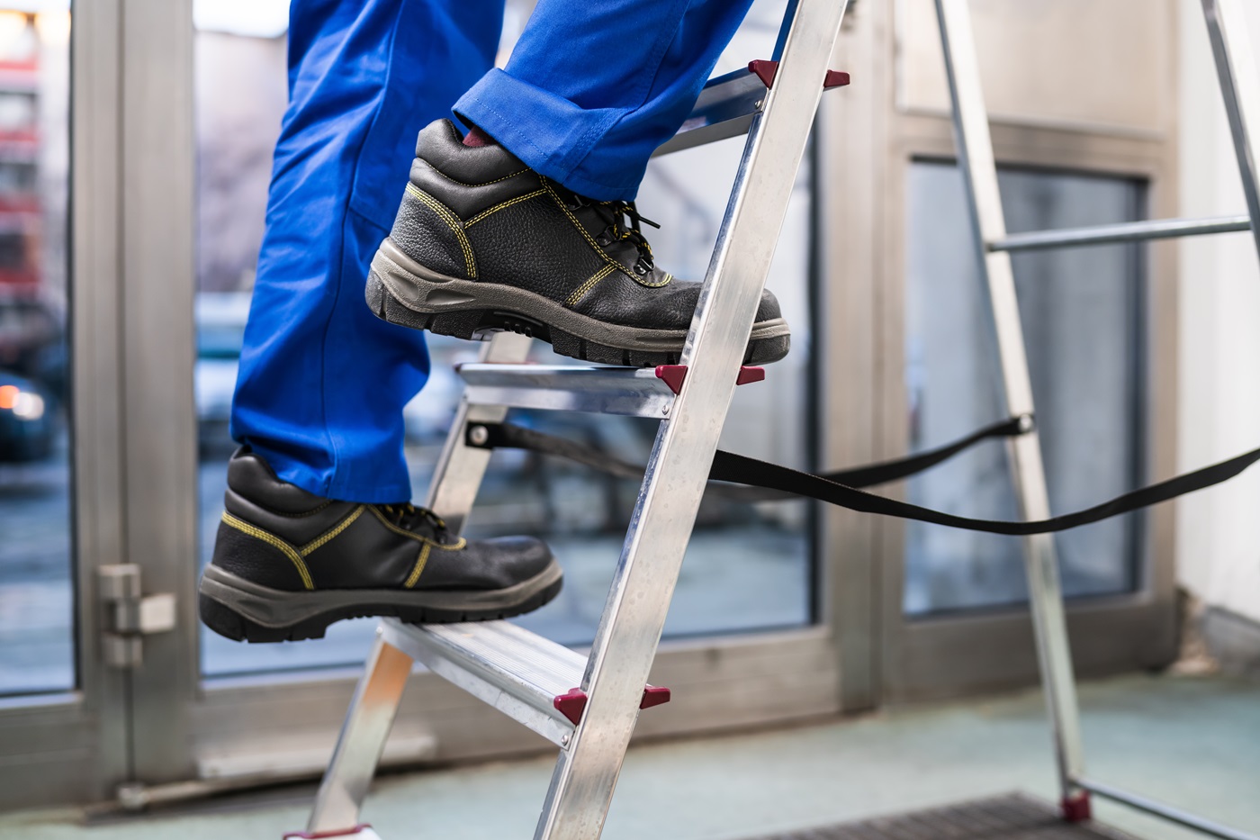 Low Section View Of A Home Inspector Foot Climbing Ladder