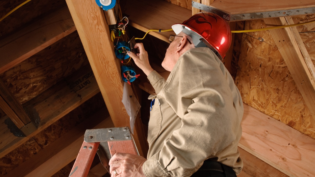 Construction inspector checking the electrical work under constructing building