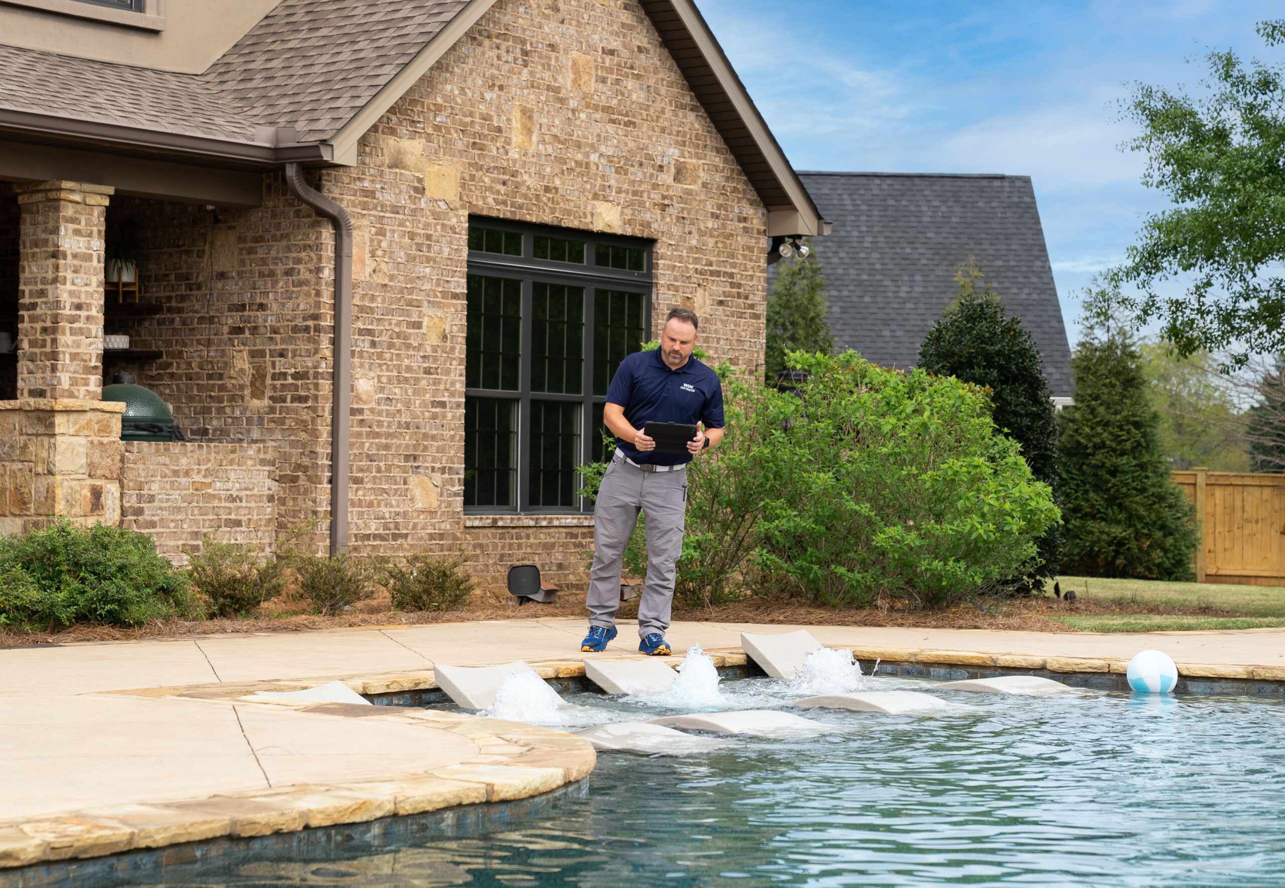 WIN home inspector inspecting a house pool