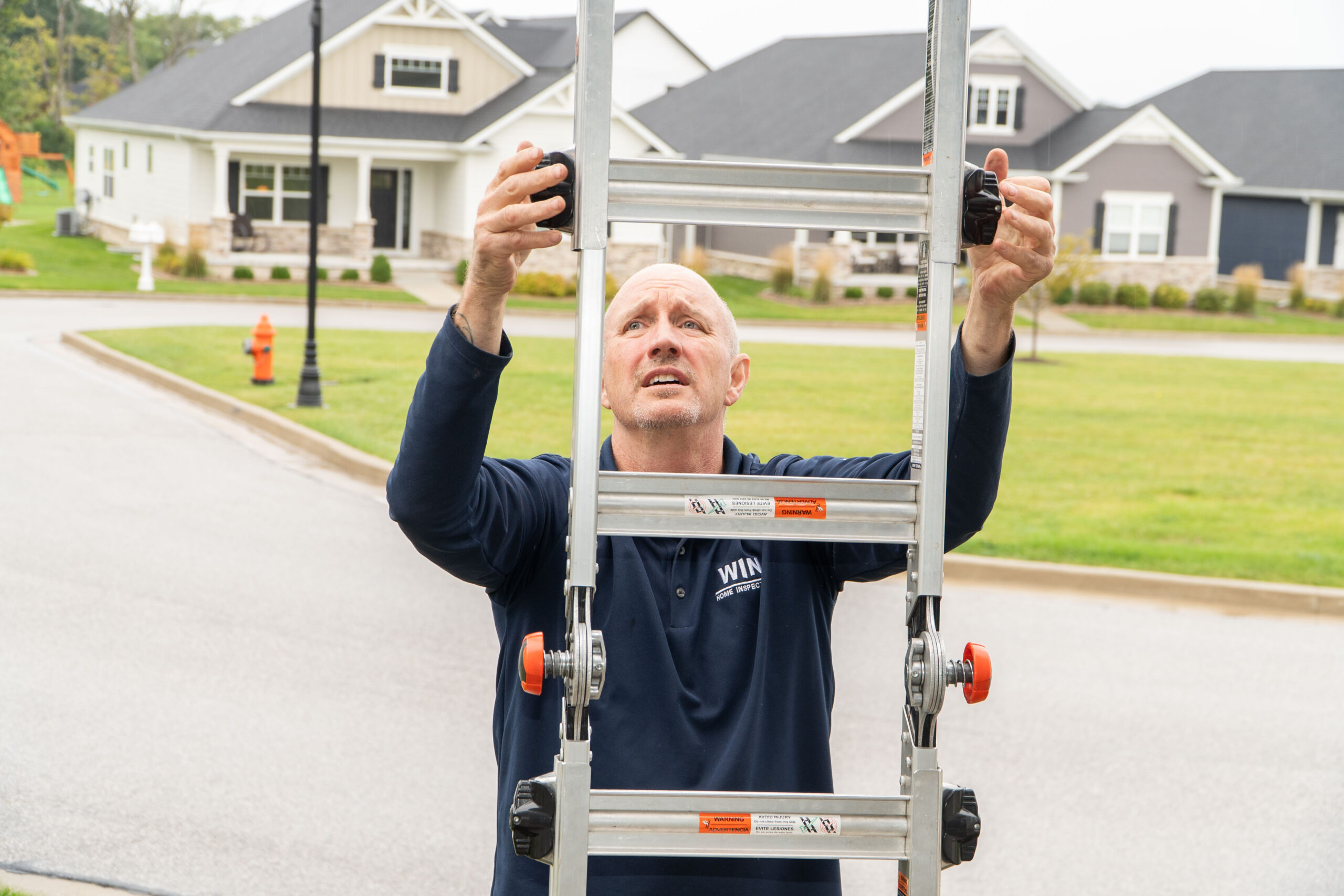 Home inspector climbing a ladder